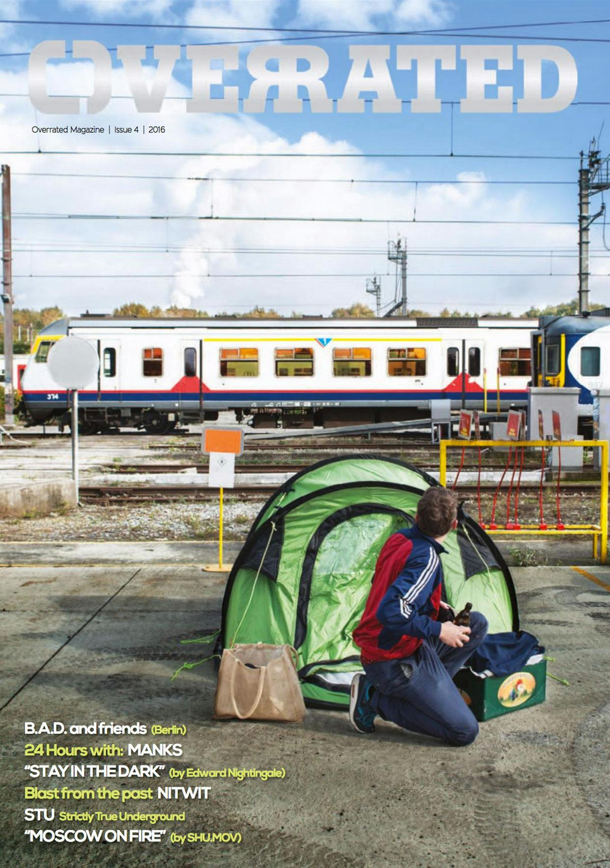 The cover of Overrated magazine issue #4 showing someone waking up from his tent on a Belgium train yard